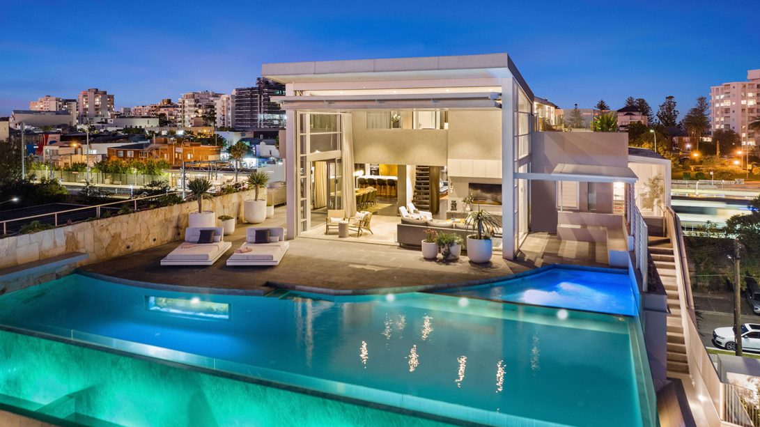Dusk exterior with infinity pool and harbour marina view