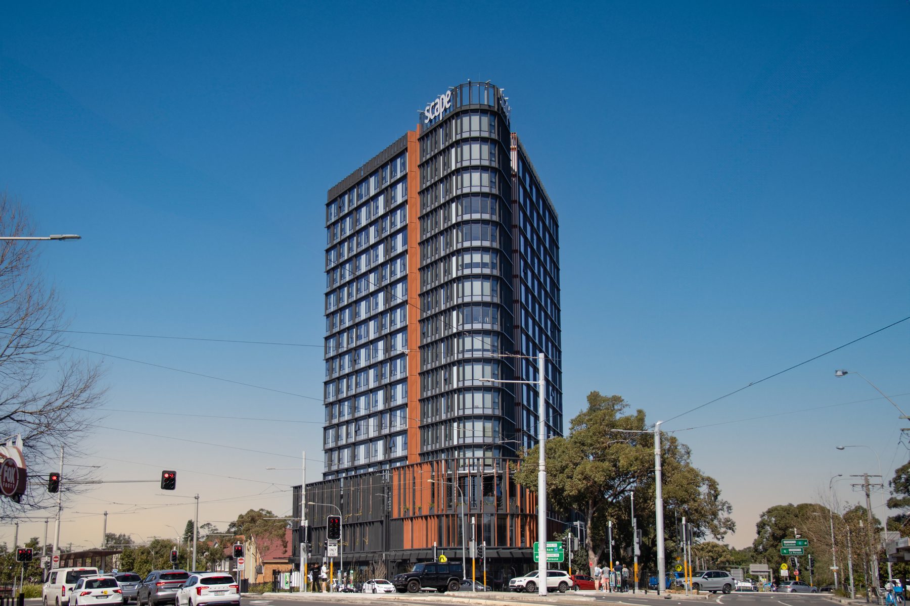 Daytime exterior of a high-rise tower on a busy intersection