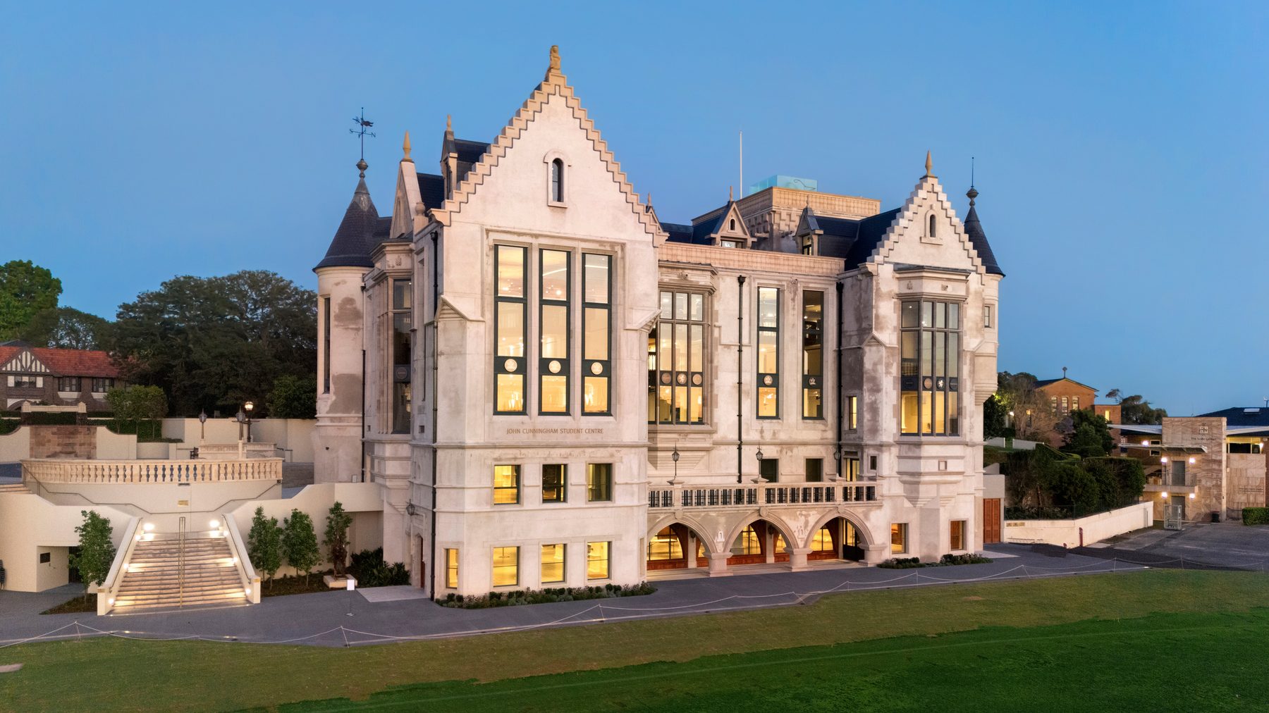 Aerial twilight view of a heritage-style stone student centre building