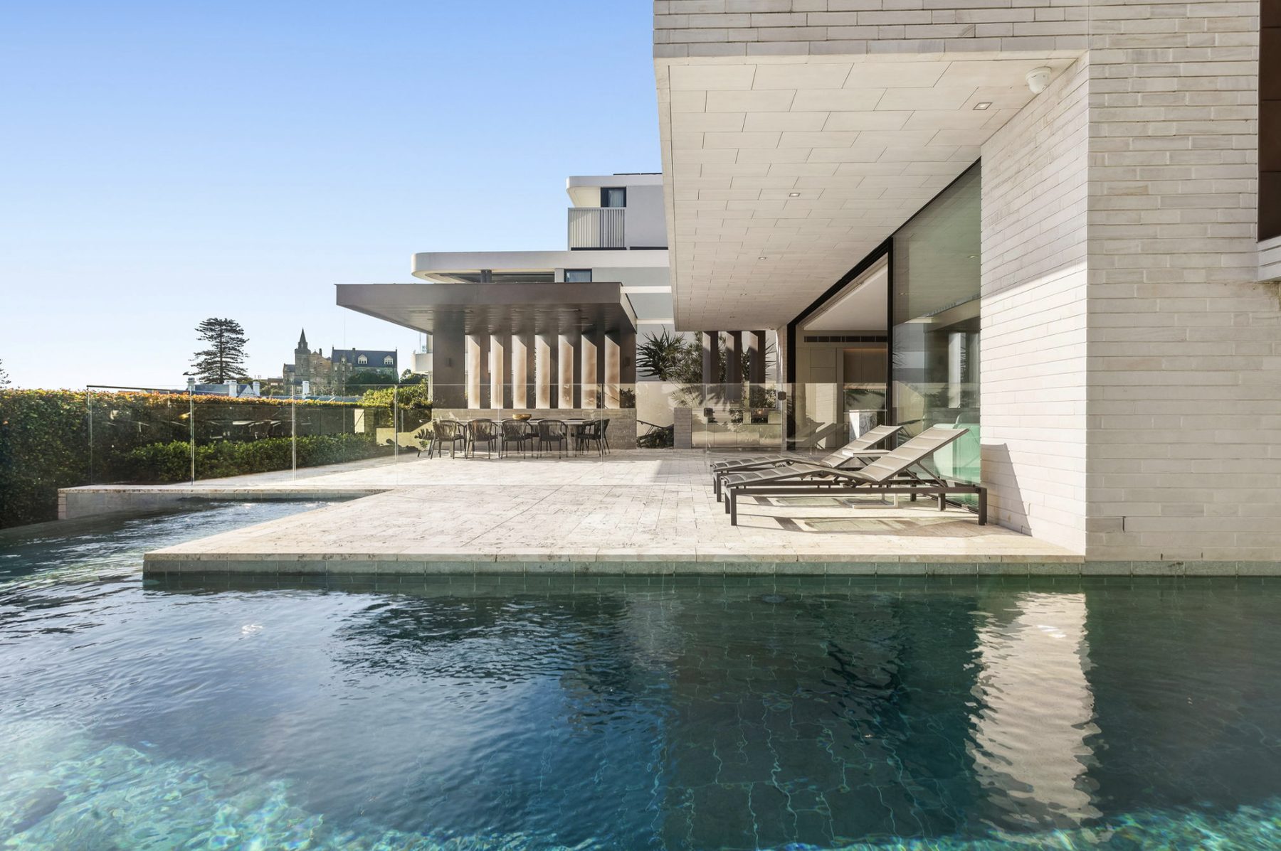 Residential pool terrace with heritage church spire in the background