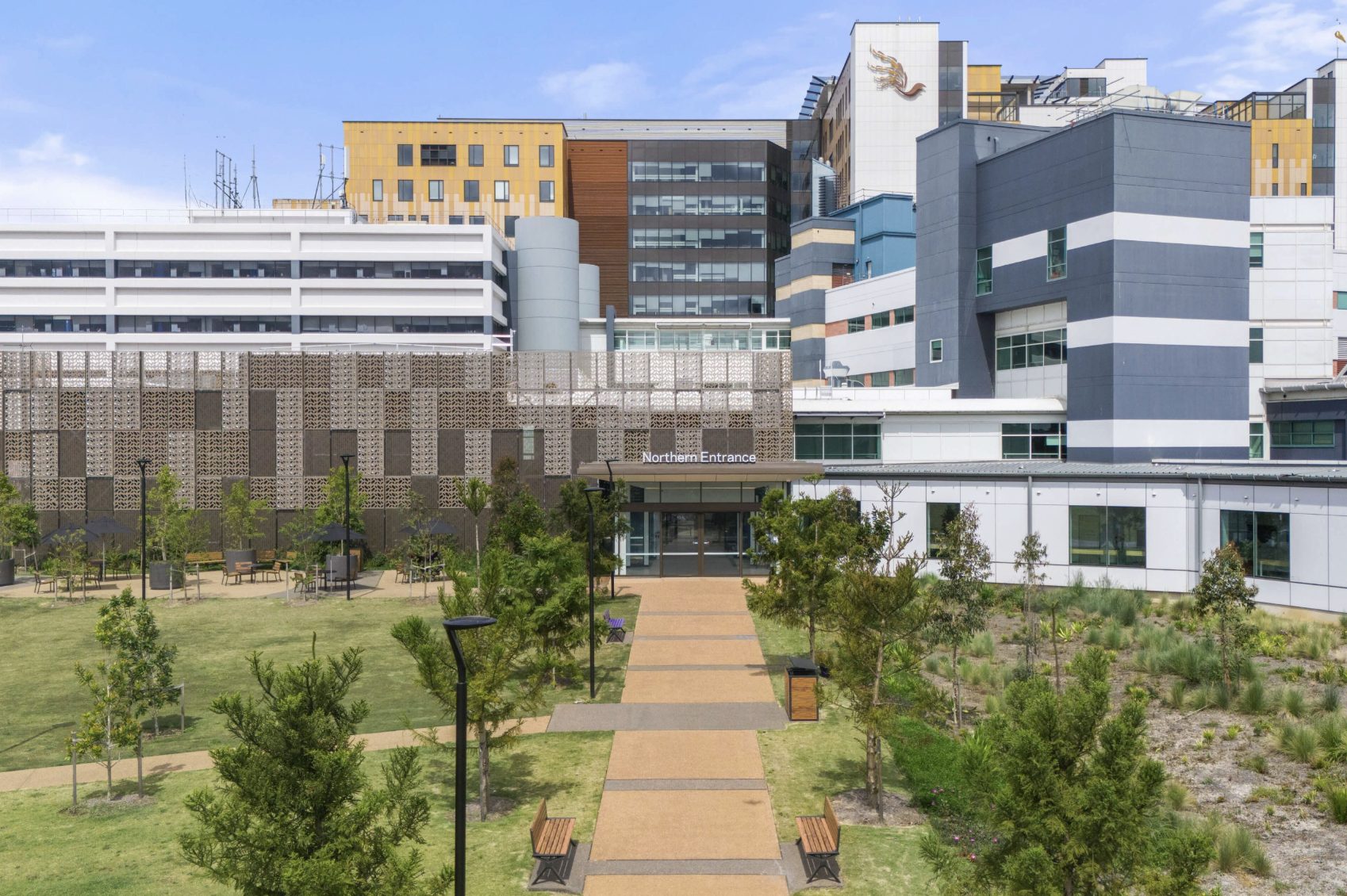 Pathway leading to a hospital's Northern Entrance with perforated facade screen