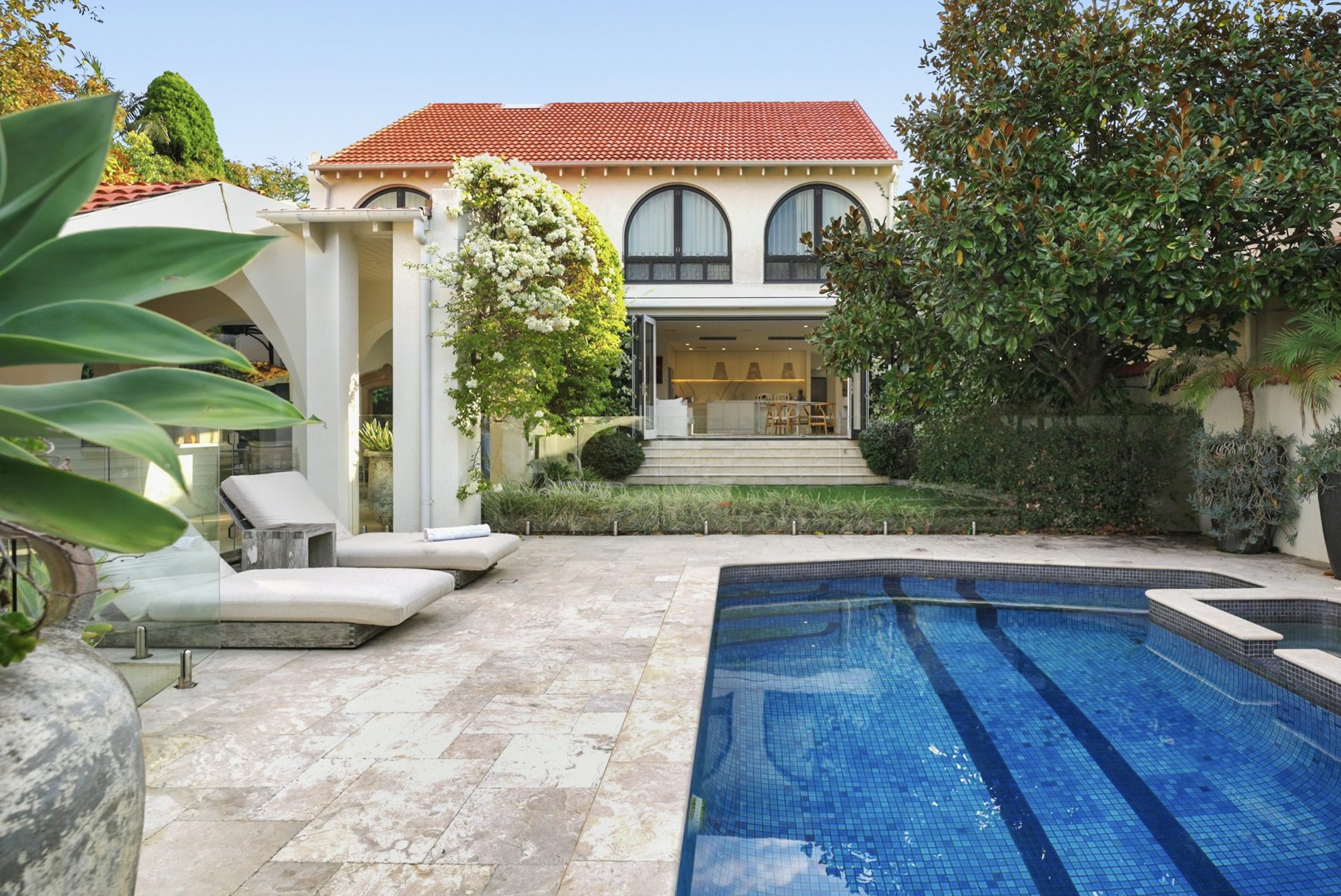 Mediterranean style residence exterior with pool and terracotta roof