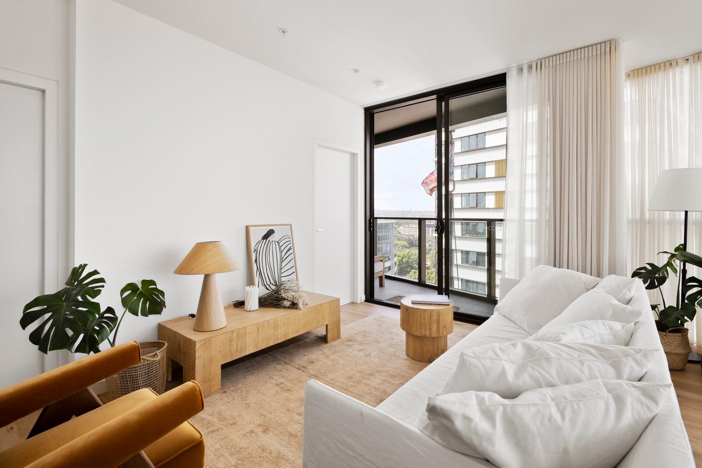 Apartment dining area with sheer curtains and city outlook