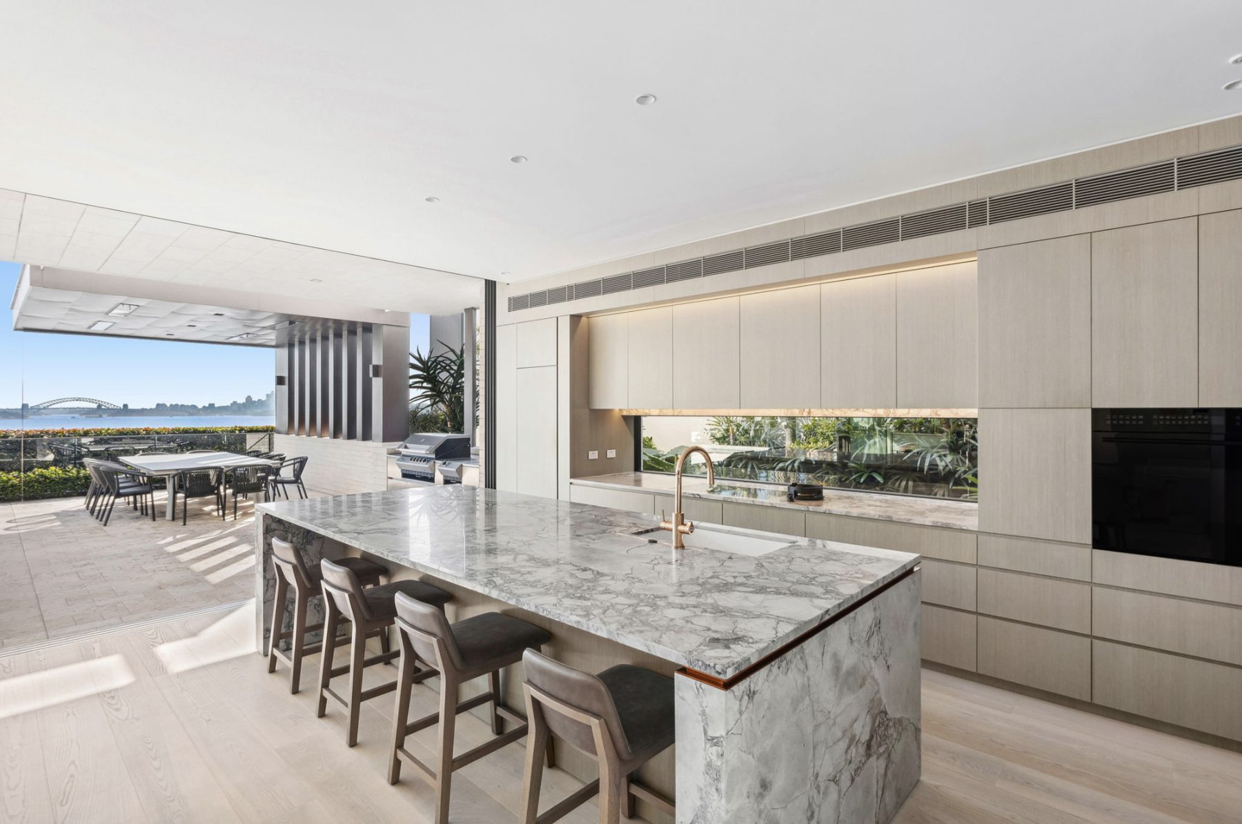 Marble kitchen island with a view of the harbour bridge through the window