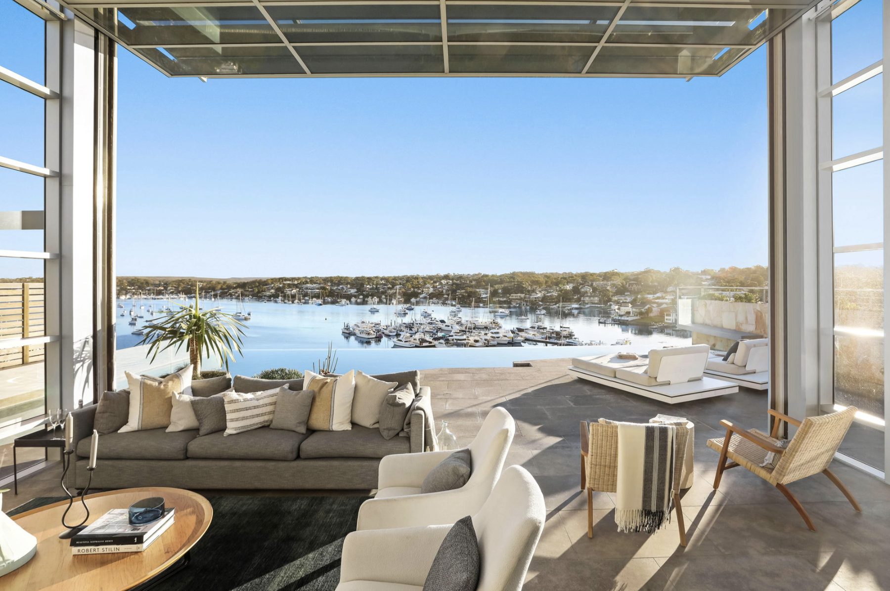 Living room open to a marina view in daylight